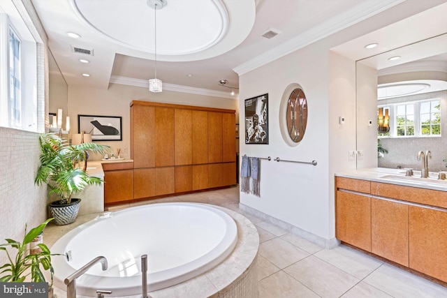 bathroom featuring crown molding, backsplash, tile patterned flooring, a tub to relax in, and vanity