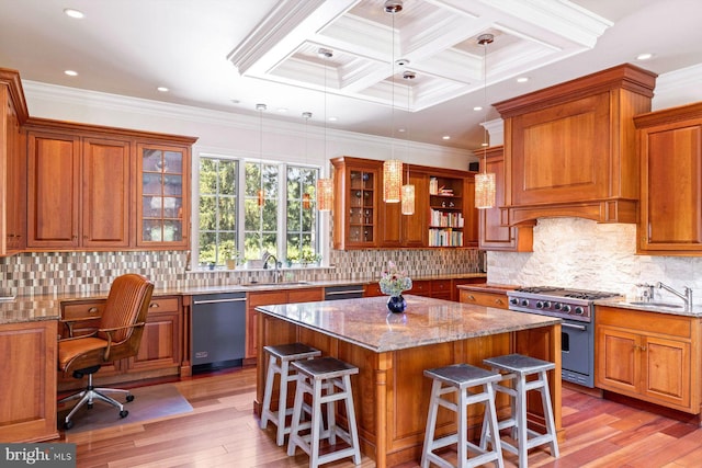 kitchen with light hardwood / wood-style flooring, light stone counters, appliances with stainless steel finishes, coffered ceiling, and a kitchen island