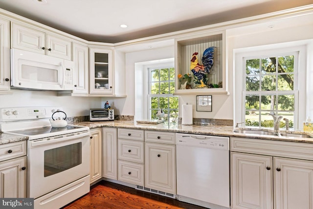 kitchen featuring dark hardwood / wood-style flooring, white appliances, sink, and light stone countertops