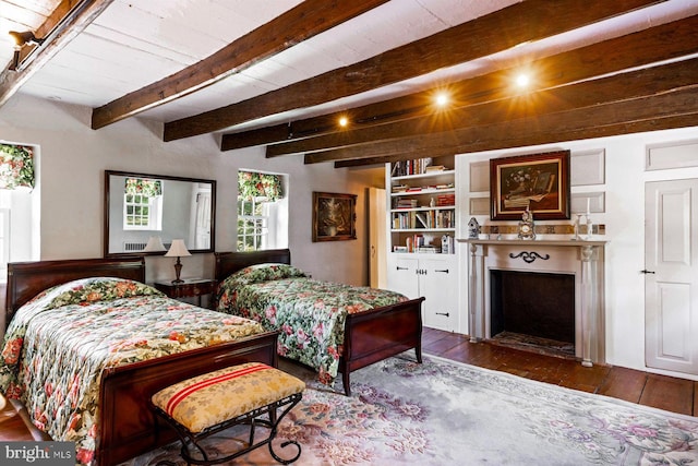 bedroom featuring beamed ceiling and dark hardwood / wood-style flooring