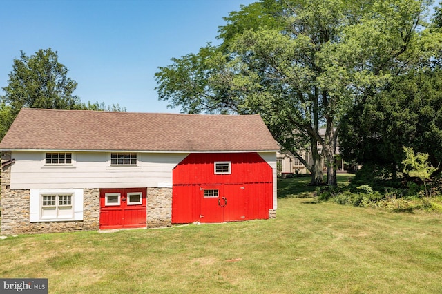 exterior space featuring an outbuilding and a front lawn