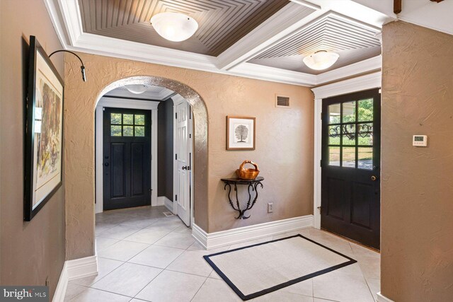 tiled entrance foyer with ornamental molding