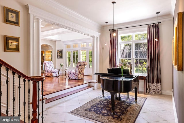 miscellaneous room with light hardwood / wood-style flooring, decorative columns, and crown molding