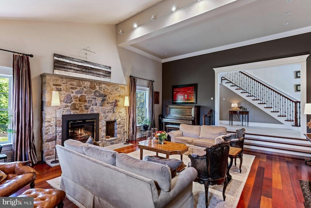 living room with a fireplace, vaulted ceiling, and hardwood / wood-style flooring