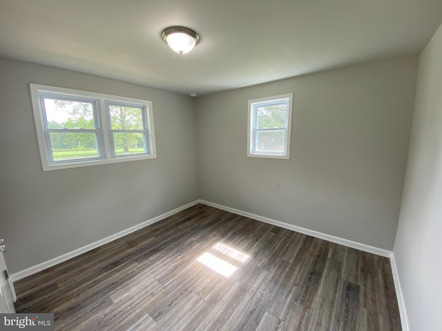 unfurnished room featuring dark hardwood / wood-style flooring