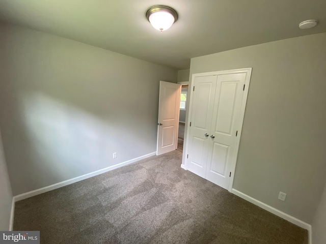 unfurnished bedroom featuring a closet and carpet flooring