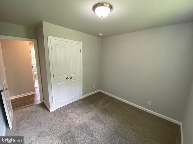 unfurnished bedroom with carpet floors and a closet