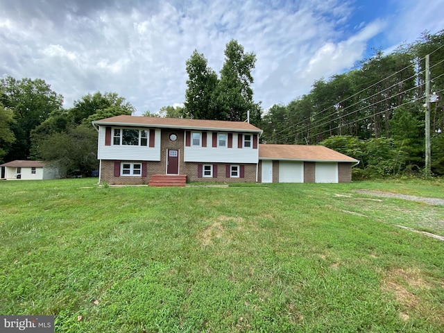 raised ranch with a garage and a front yard