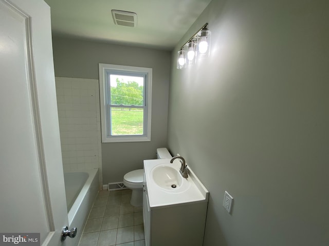 bathroom featuring vanity, tile patterned floors, and toilet