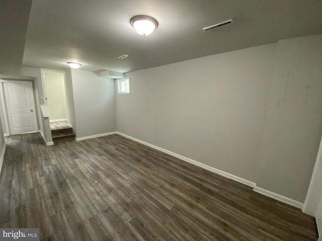 basement with dark hardwood / wood-style floors