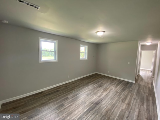 empty room with dark wood-type flooring