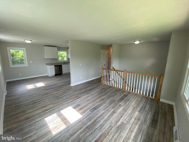 unfurnished living room with dark wood-type flooring