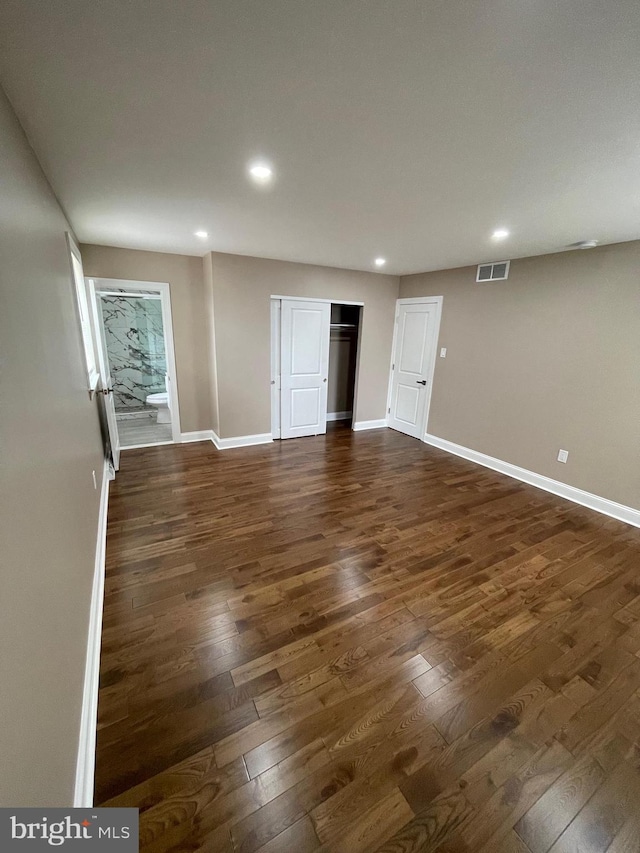 empty room with dark wood-type flooring