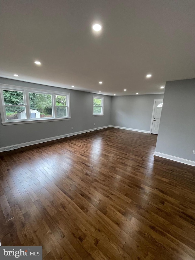 unfurnished room with dark wood-type flooring