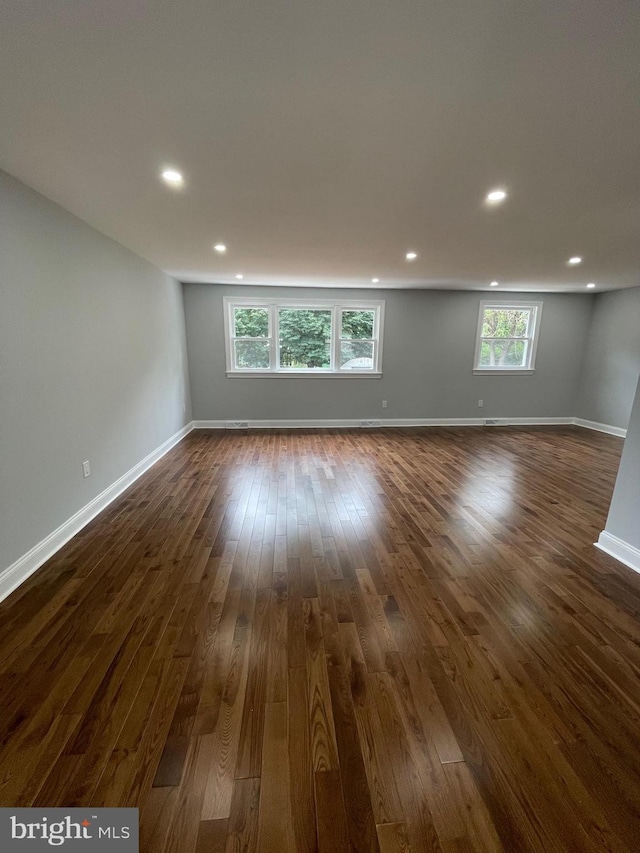 empty room with dark hardwood / wood-style floors