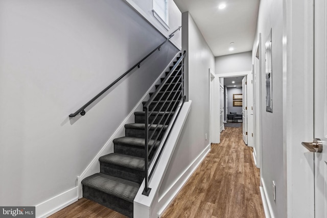 staircase with hardwood / wood-style flooring