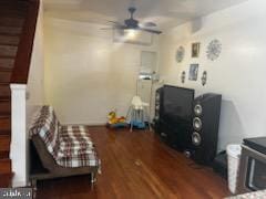 living area with ceiling fan and hardwood / wood-style flooring