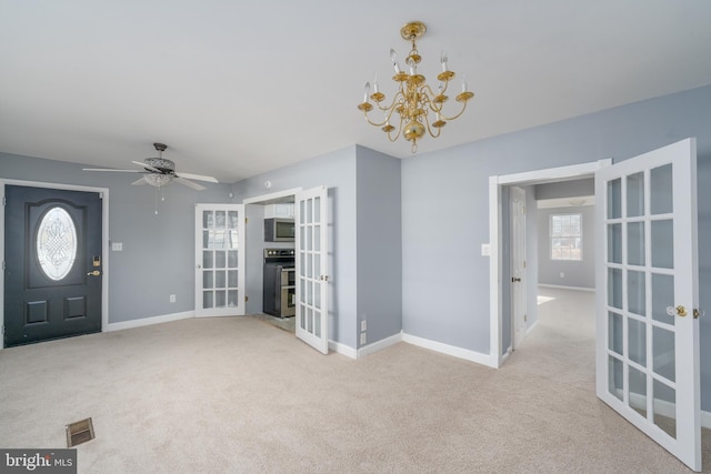 entryway with a wealth of natural light, light colored carpet, and french doors