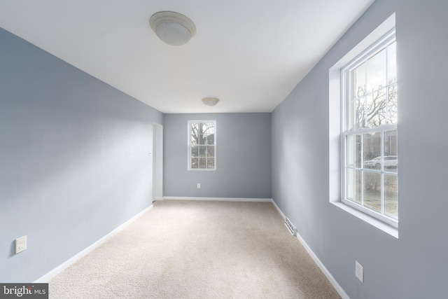 unfurnished room featuring carpet flooring and a wealth of natural light