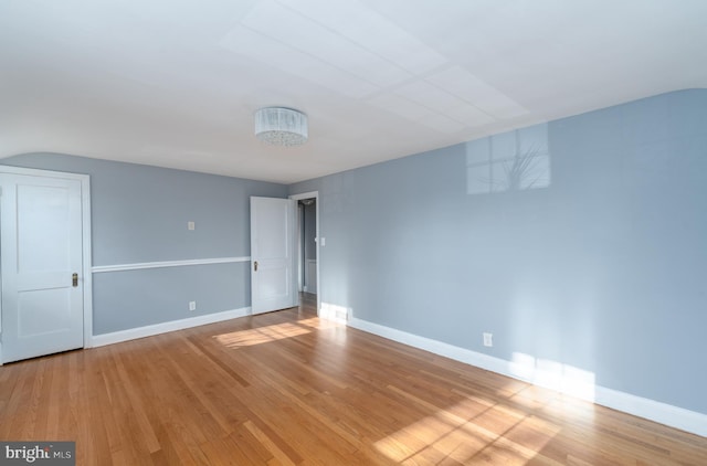 empty room with light hardwood / wood-style flooring