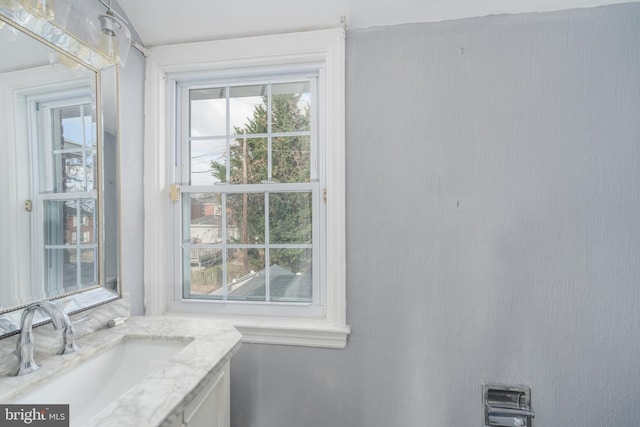 bathroom featuring a healthy amount of sunlight and vanity