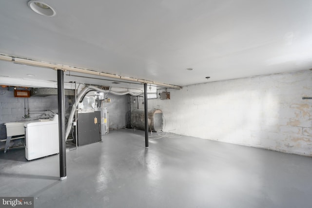 basement with sink, washer / clothes dryer, and electric water heater