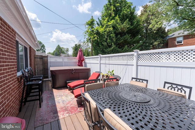 wooden terrace featuring a hot tub