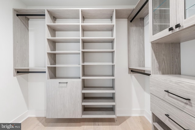 walk in closet featuring light hardwood / wood-style floors