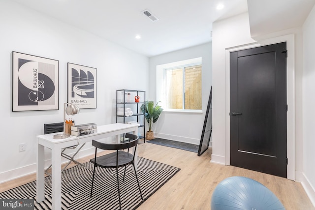 home office with light hardwood / wood-style floors