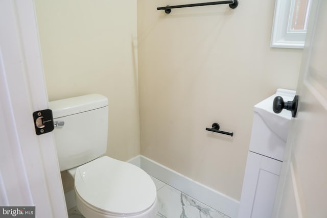 bathroom featuring marble finish floor, vanity, toilet, and baseboards