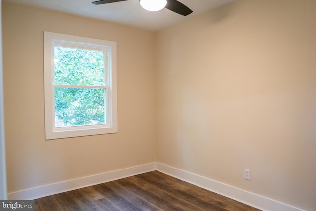 unfurnished room featuring a ceiling fan, dark wood finished floors, and baseboards