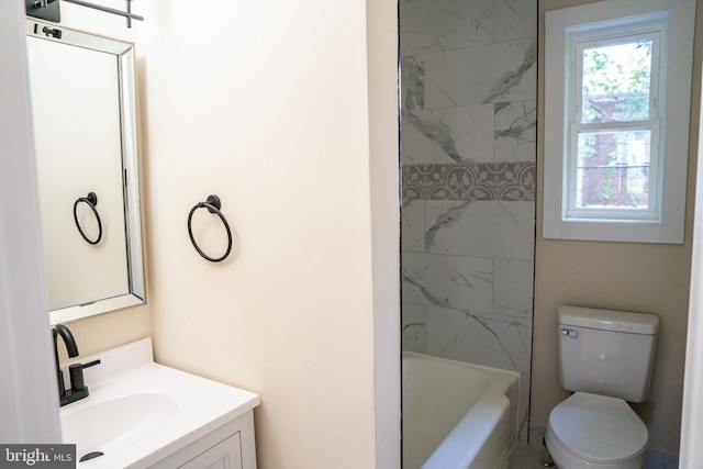 full bathroom featuring washtub / shower combination, vanity, and toilet