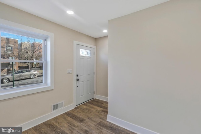 entryway with dark wood-style floors, visible vents, baseboards, and recessed lighting