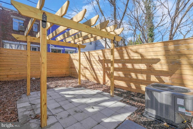 view of patio featuring central AC, a fenced backyard, and a pergola