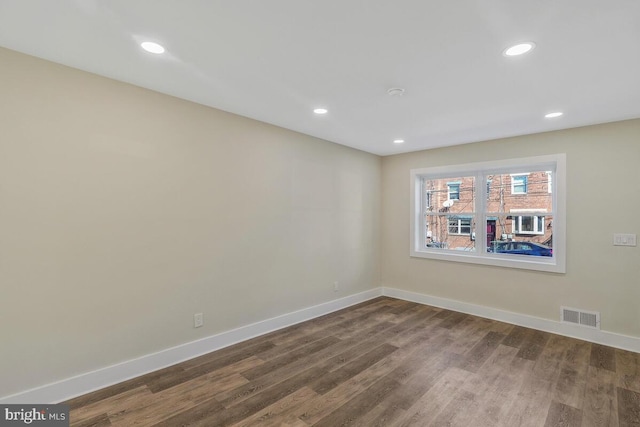 spare room featuring recessed lighting, visible vents, baseboards, and wood finished floors