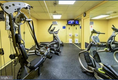 workout area with a paneled ceiling