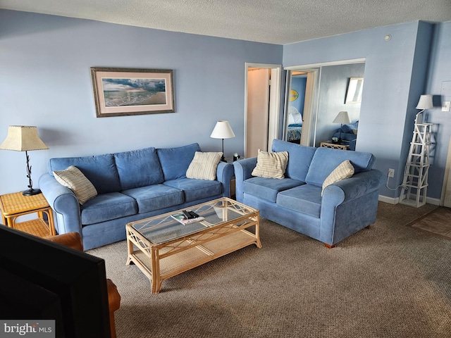 living area with a textured ceiling, carpet, and baseboards