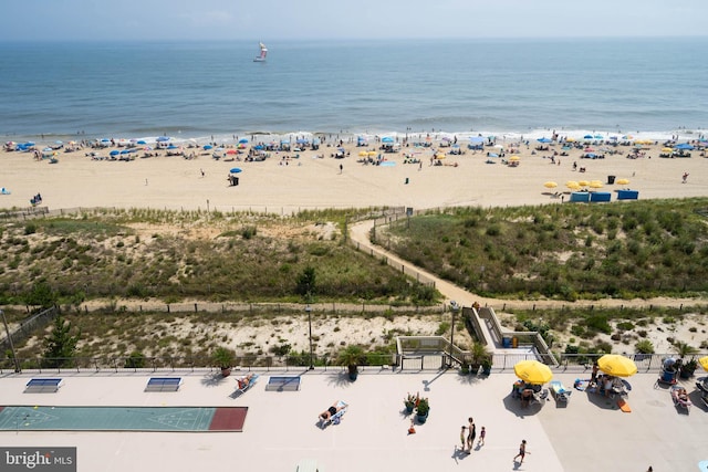 bird's eye view featuring a water view and a beach view