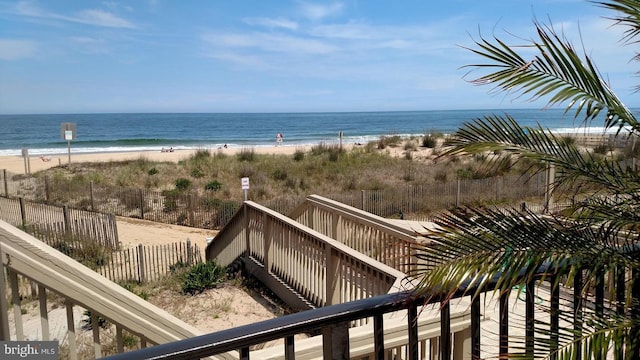 water view featuring a view of the beach and fence