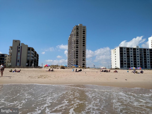 view of property featuring a city view, a beach view, and a water view