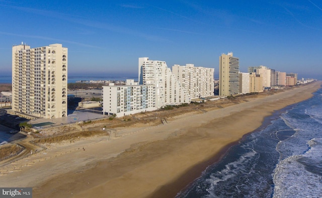 aerial view with a view of the beach, a water view, and a view of city