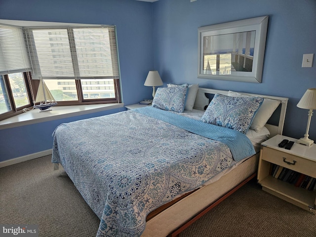 carpeted bedroom featuring baseboards