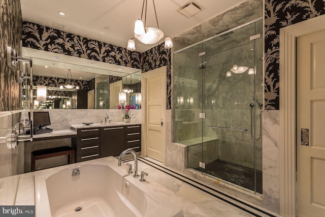 bathroom with vanity and separate shower and tub