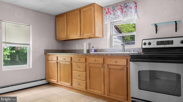 kitchen with a baseboard heating unit, light tile patterned floors, and stainless steel range with electric stovetop