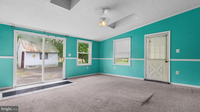 unfurnished room with ceiling fan, lofted ceiling, light colored carpet, and a textured ceiling