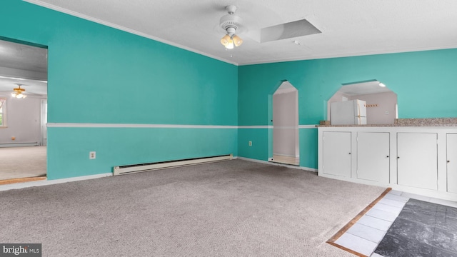 carpeted empty room featuring a baseboard radiator, ornamental molding, and ceiling fan