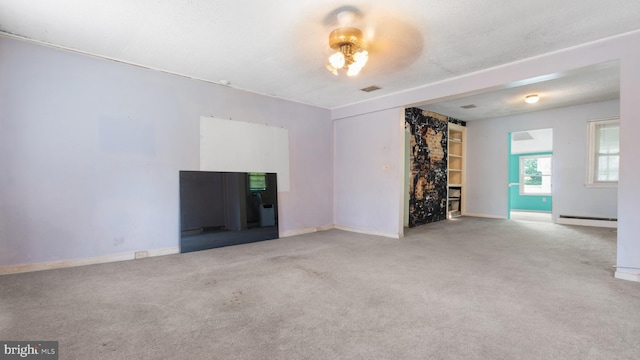 unfurnished living room with baseboard heating and carpet floors