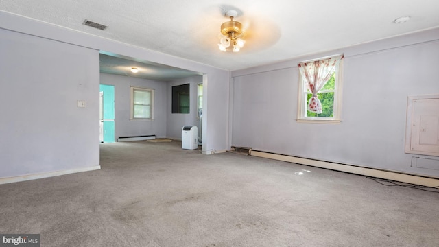 spare room featuring light carpet, a baseboard radiator, and electric panel