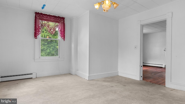 unfurnished room with crown molding, a baseboard heating unit, and light carpet