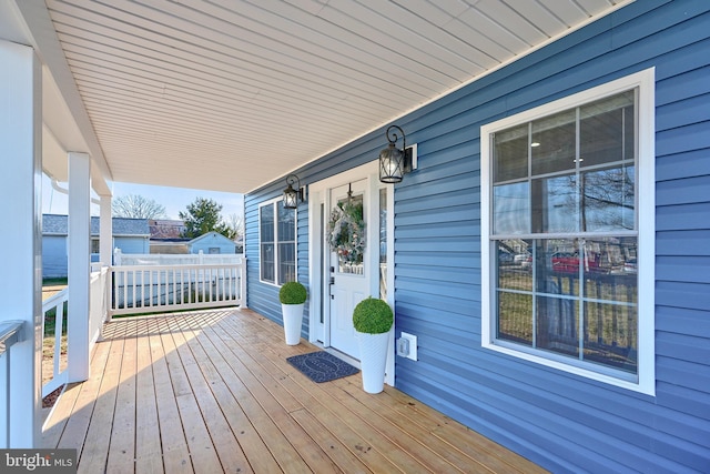 wooden terrace featuring covered porch